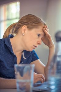 Woman looking worried at her desk