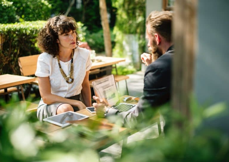 Man and woman talking outside