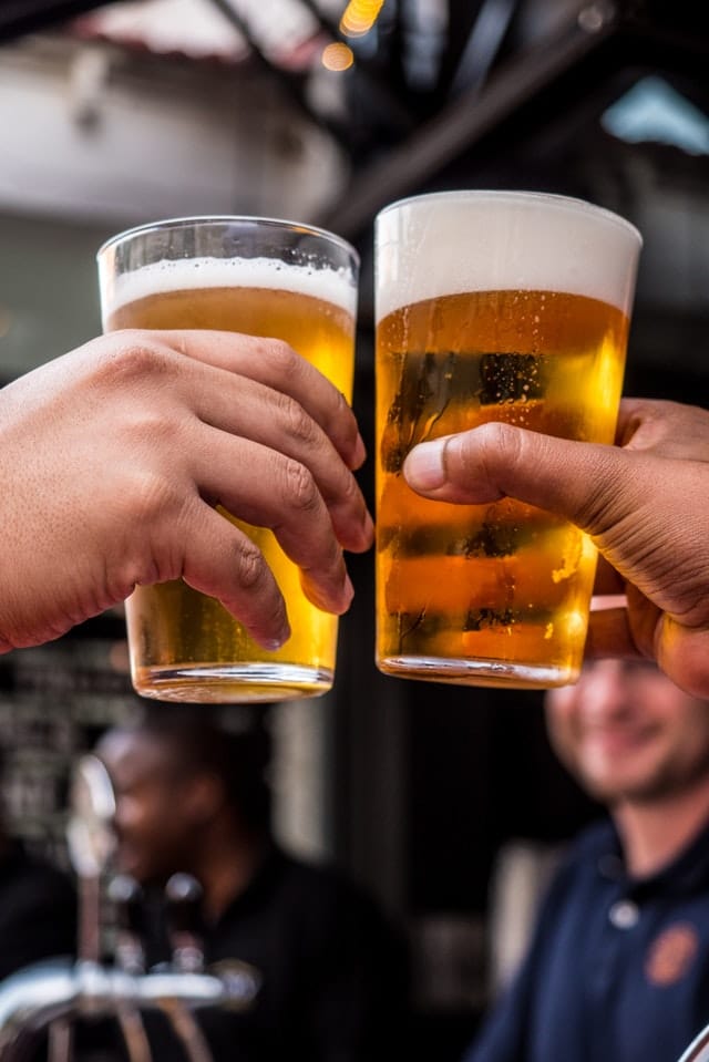 two pint glasses filled with peer