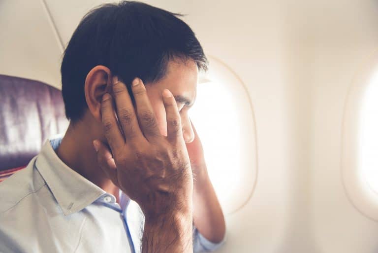 Male passenger having ear pop on the airplane