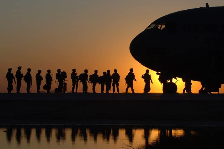 US soldiers boarding an airplane.