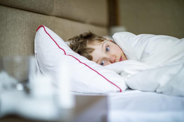 Sick kid lying in bed