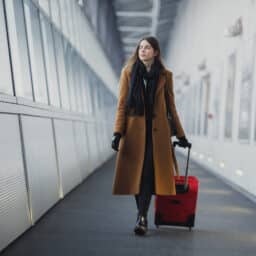 Woman walking with luggage in an airport