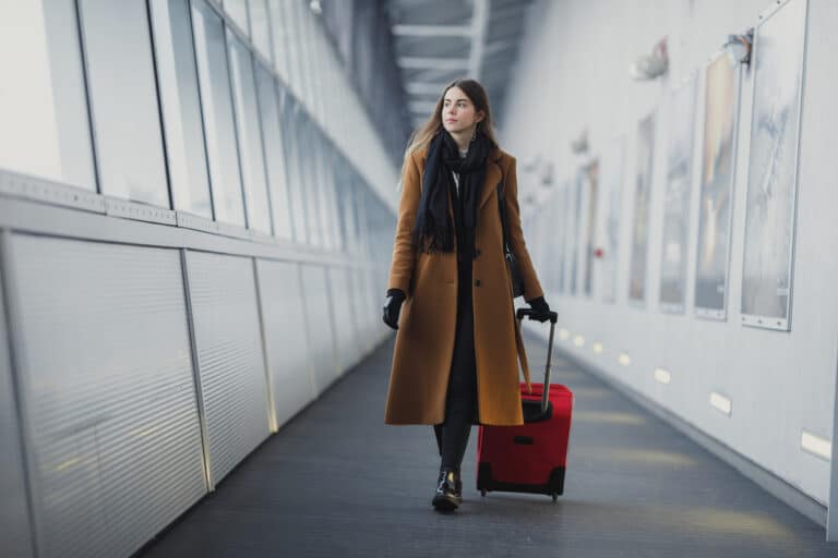 Woman walking with luggage in an airport